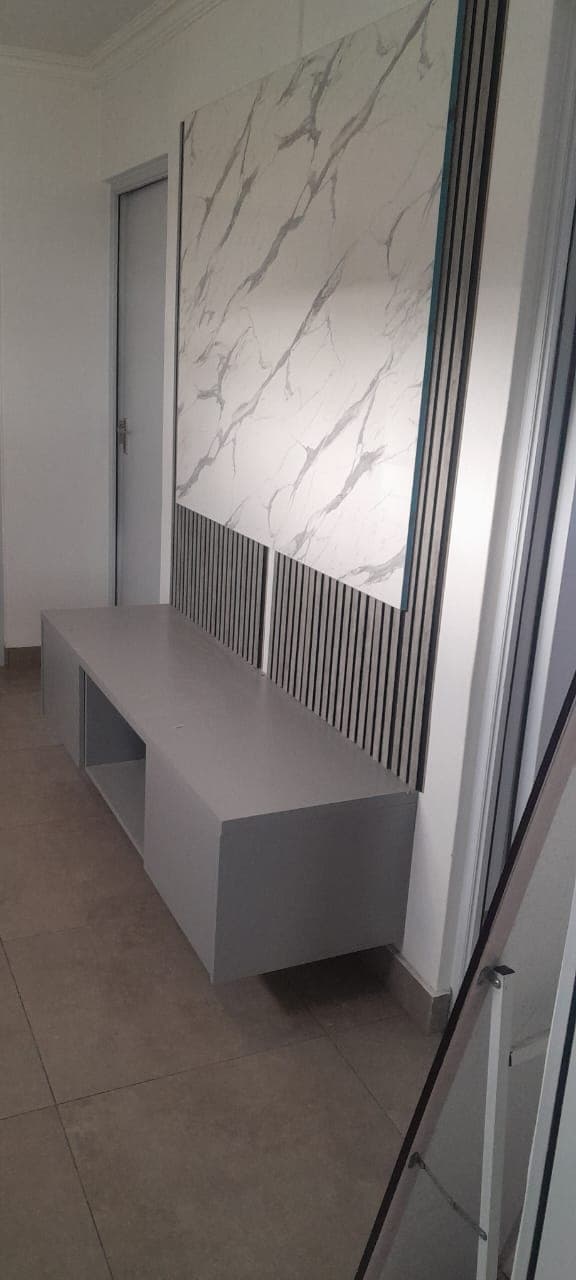 Floating grey TV unit with marble accent wall